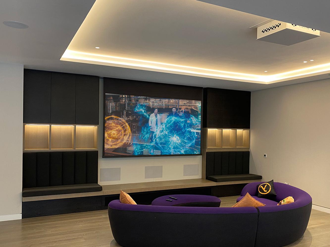 Projector screen in front of tv purple sofa