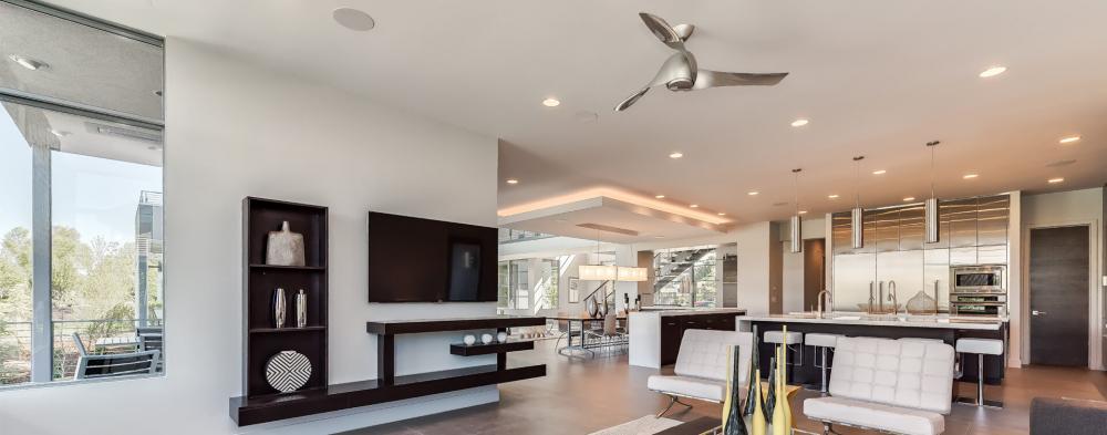 In ceiling speakers in a white open space large modern kitchen 