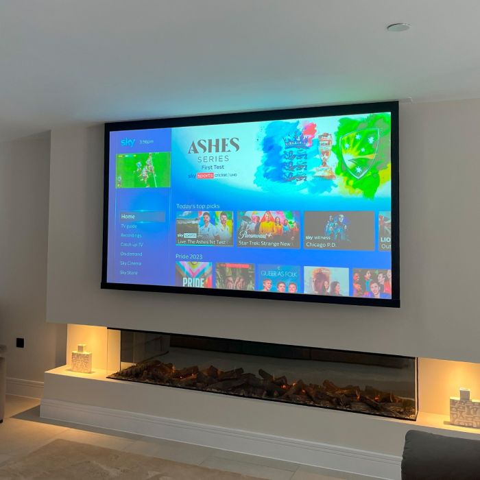In Ceiling electric projector screen on media wall above fireplace