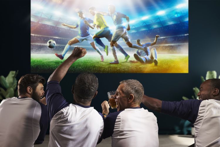 men enjoying football on a projector screen whilst drinking