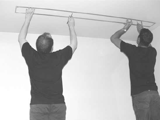 two men fitting projector screen